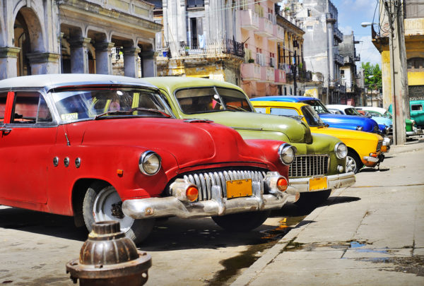 Detail of colorful group of vintage american cars parked in a street of Old havana