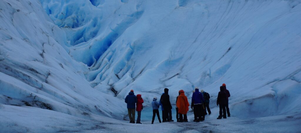 teachers, students, and their Vamonos Tours guide hike glaciers in Patagonia